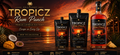 Tropicz Rum Punch in three packaging sizes (250ml single serve pouch, 500ml single serve pouch, and 11L bottle) displayed against a tropical sunset beach backdrop with pineapples, mangoes, and passion fruit props.